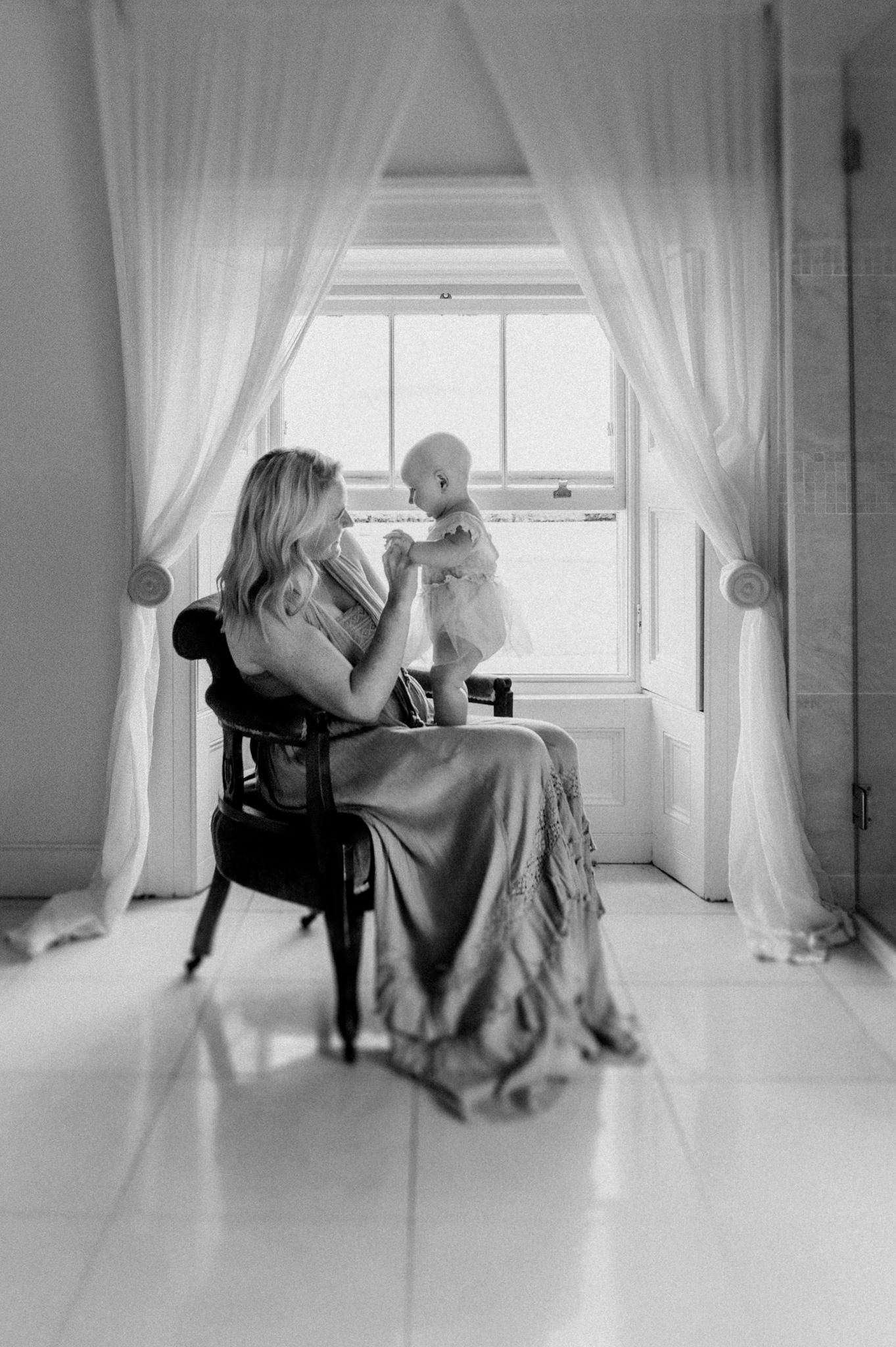 mother-and-baby-daughter-at-the-window-Rockfield-House-Kells-kristina-kelly-photography
